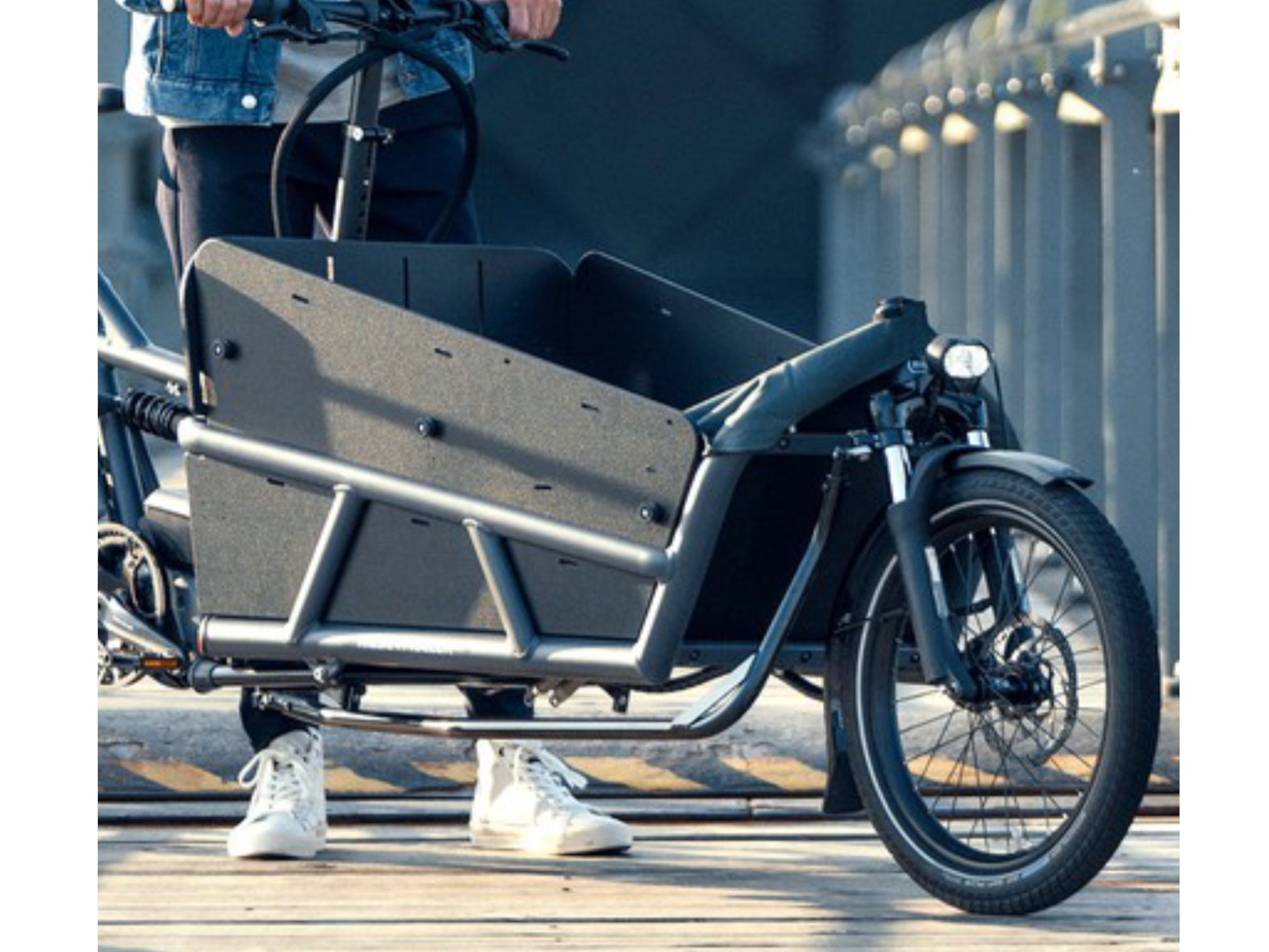 Riese and Muller Load 75 Touring HS eMTB full suspension man standing on bridge cargo area high sidewalls