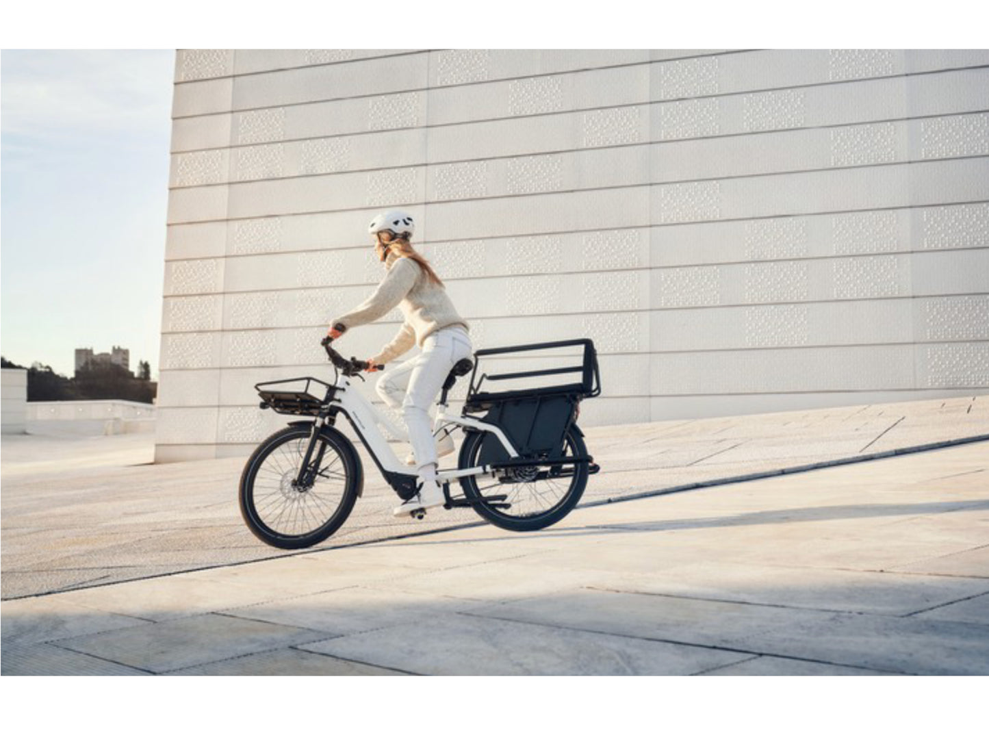 Riese and Muller Multicharger Mixte GT Touring HS emtb hardtail woman riding city street commuter