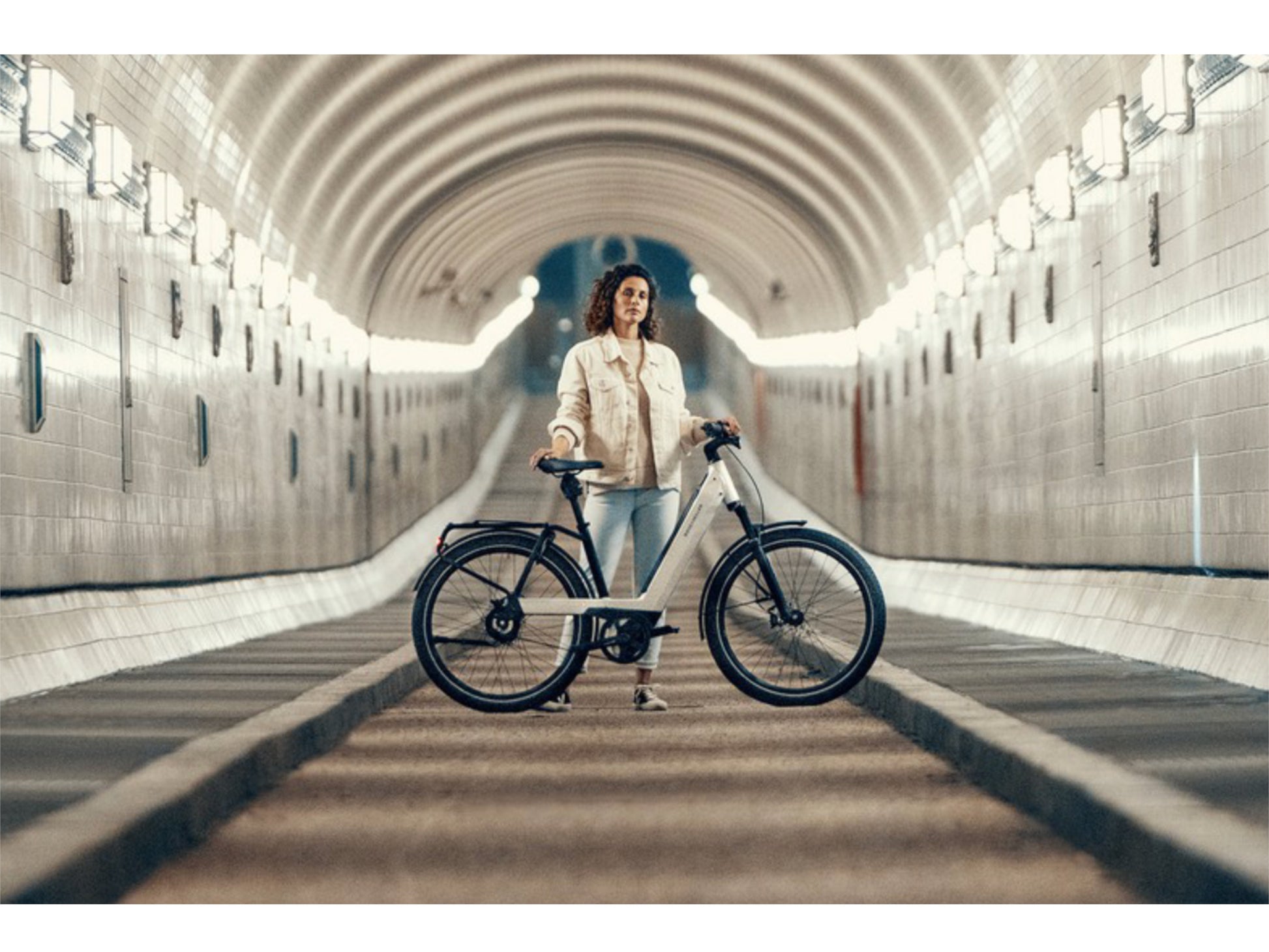 Riese and Muller Nevo GT Rohloff emtb hardtail woman in city tunnel bike path