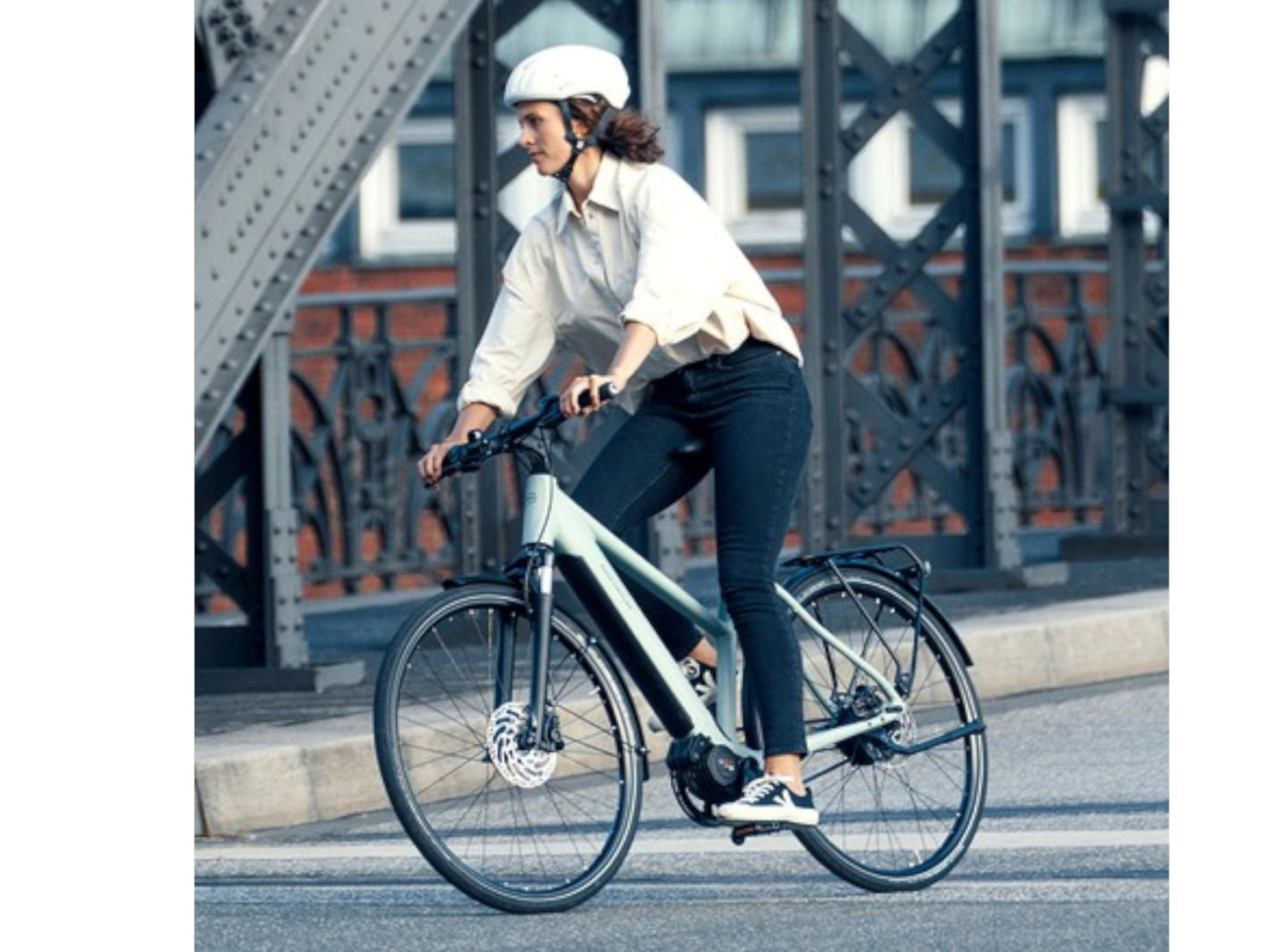 Riese and Muller Roadster Mixte Vario eMTB hardtail woman commuting on city streets
