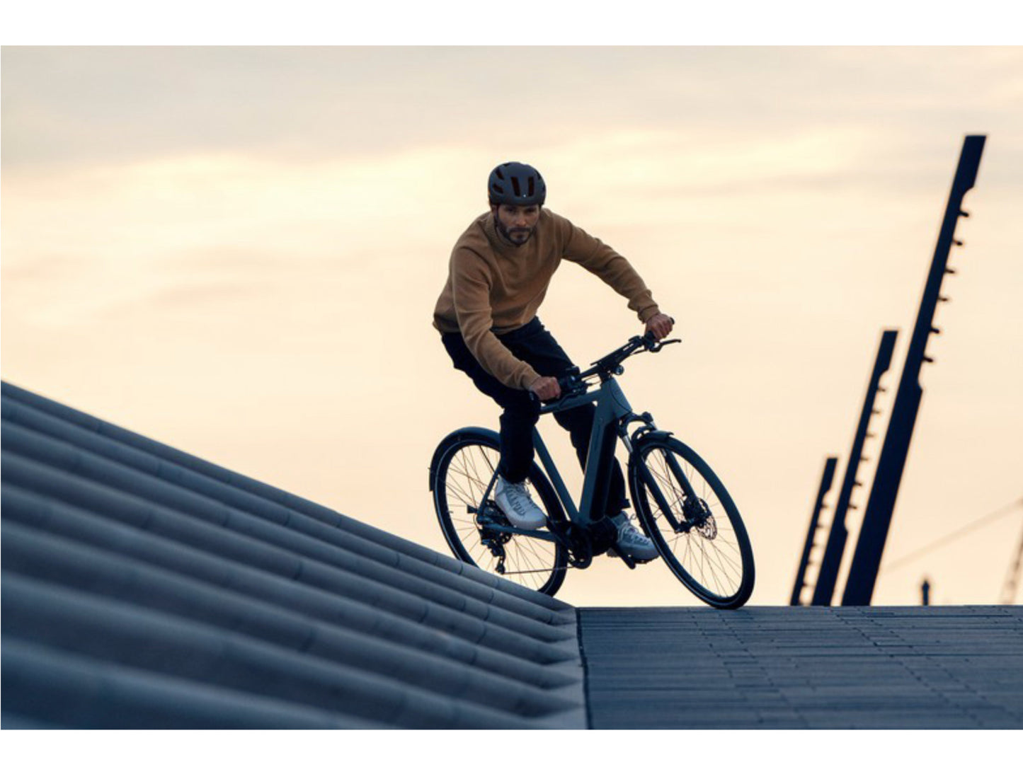 Riese and Muller Roadster Vario eMTB hardtail man riding through city square