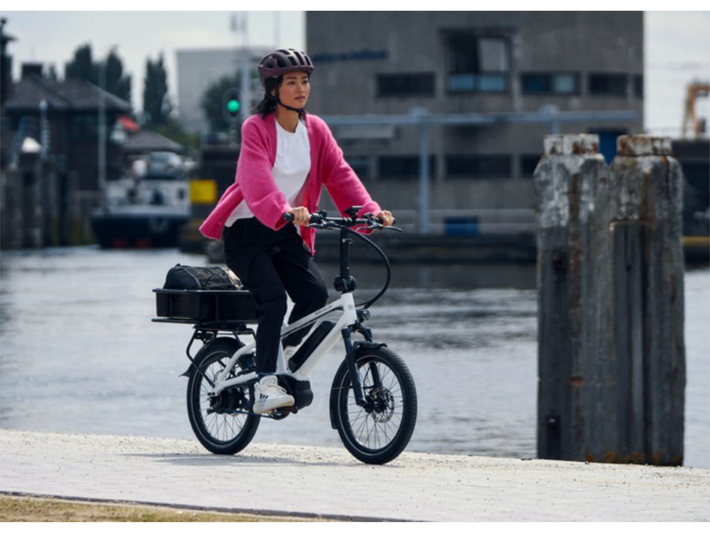 Riese & Muller Tinker2 Vario eMtb hardtail crystal white woman riding waterside with cargo platform