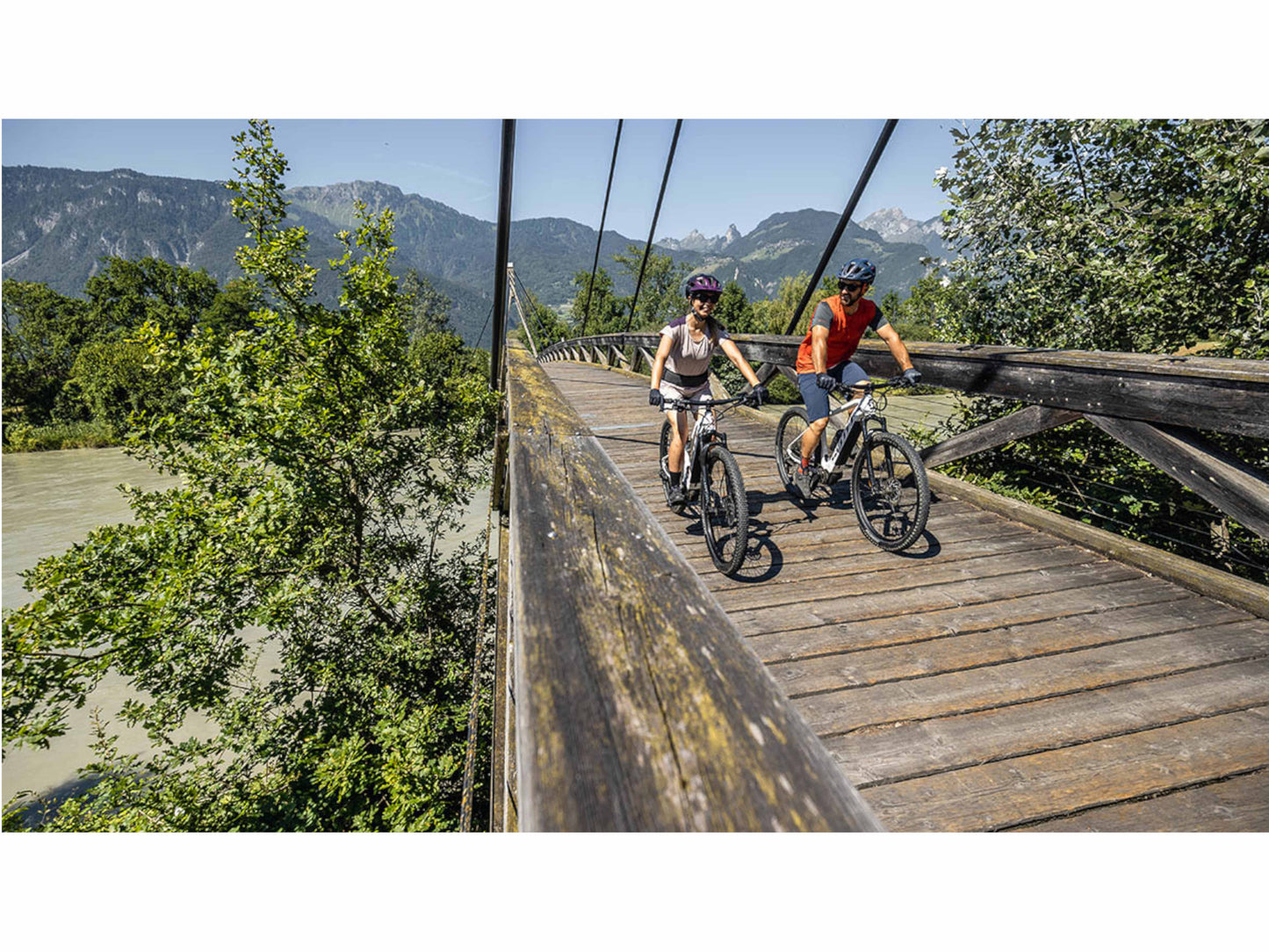 Scott Aspect eRide 920 eMTB hard tail couple riding across bridge country side