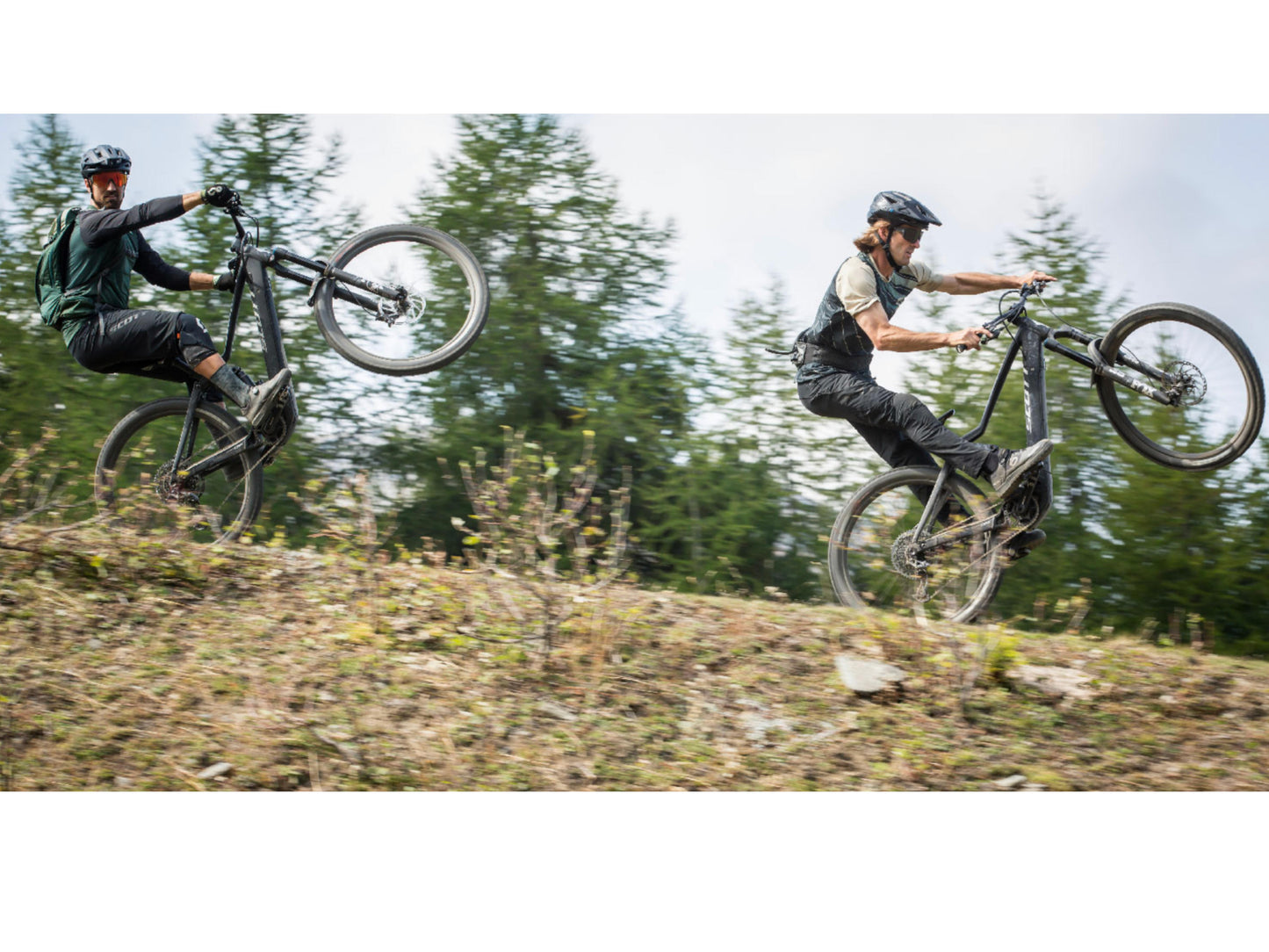 Scott Ransom eRide 920 eMtb full suspension two men popping wheelies on mountain single track