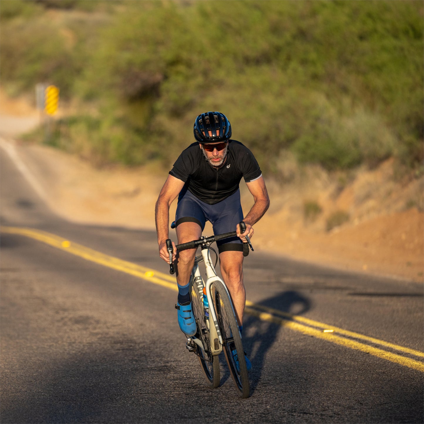 Smith Optics Persist MIPS Road Helmet man riding uphill on street