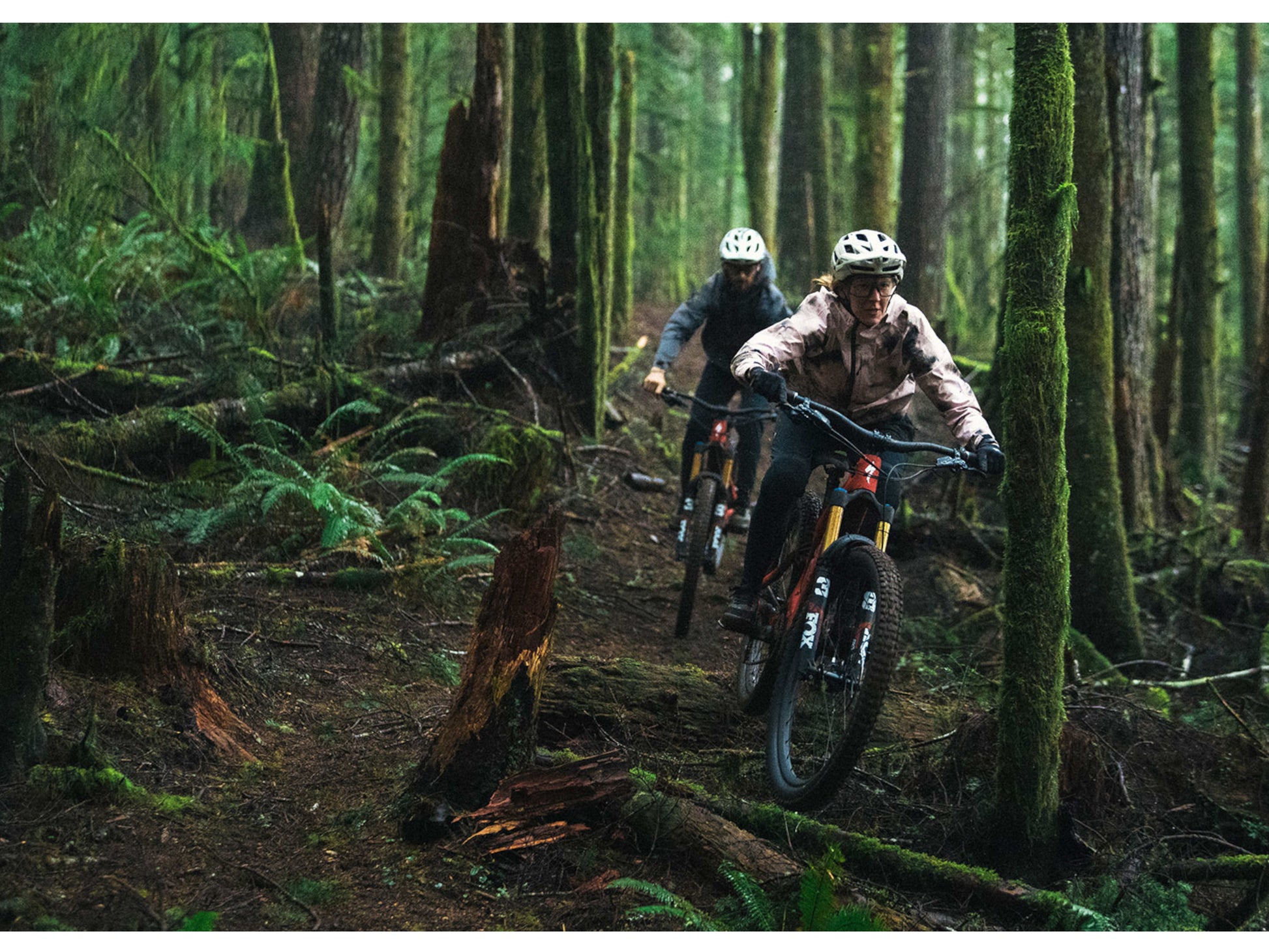 Specialized Turbo Levo Carbon eMtb full suspension man and woman riding trail through forest