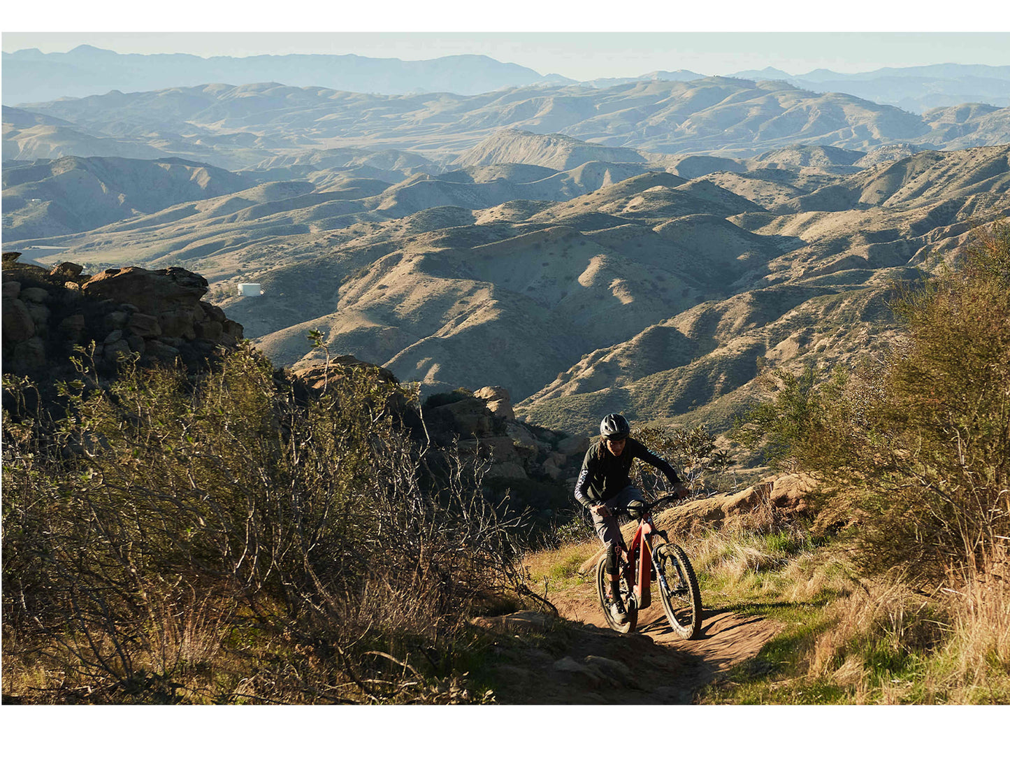 Specialized Turbo Levo Pro emtb satin redwood smoke black action aerial view mountain trail