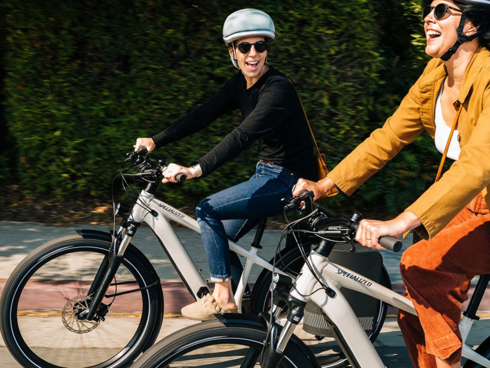 Specialized Turbo Vado 5.0 IGH eMTB hardtail two women riding together on city street