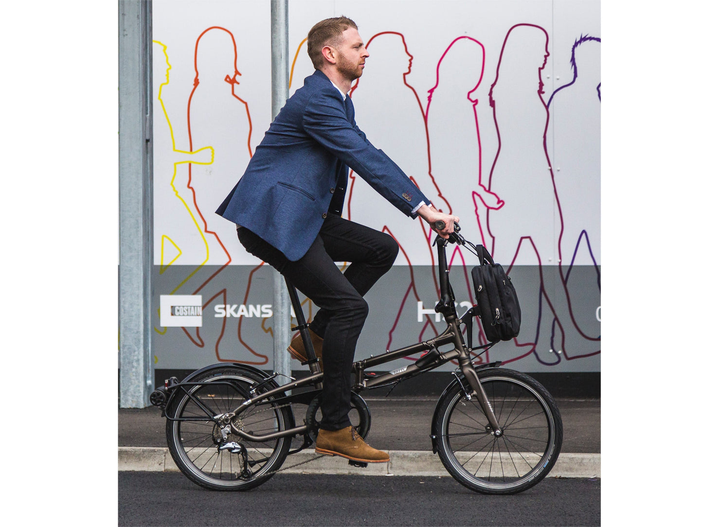 Tern BYB P10 Compact folding bike. Man on a city commute ride in his suit