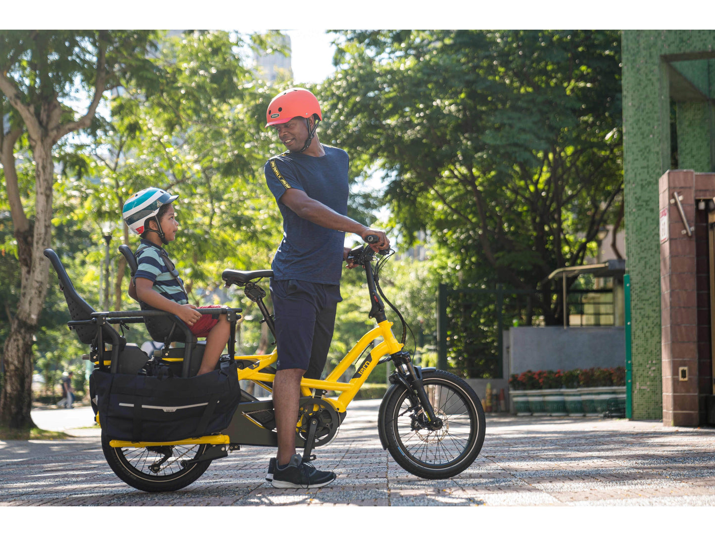 Tern GSD S10 LX electric cargo bike yellow action photo kid on cargo rack