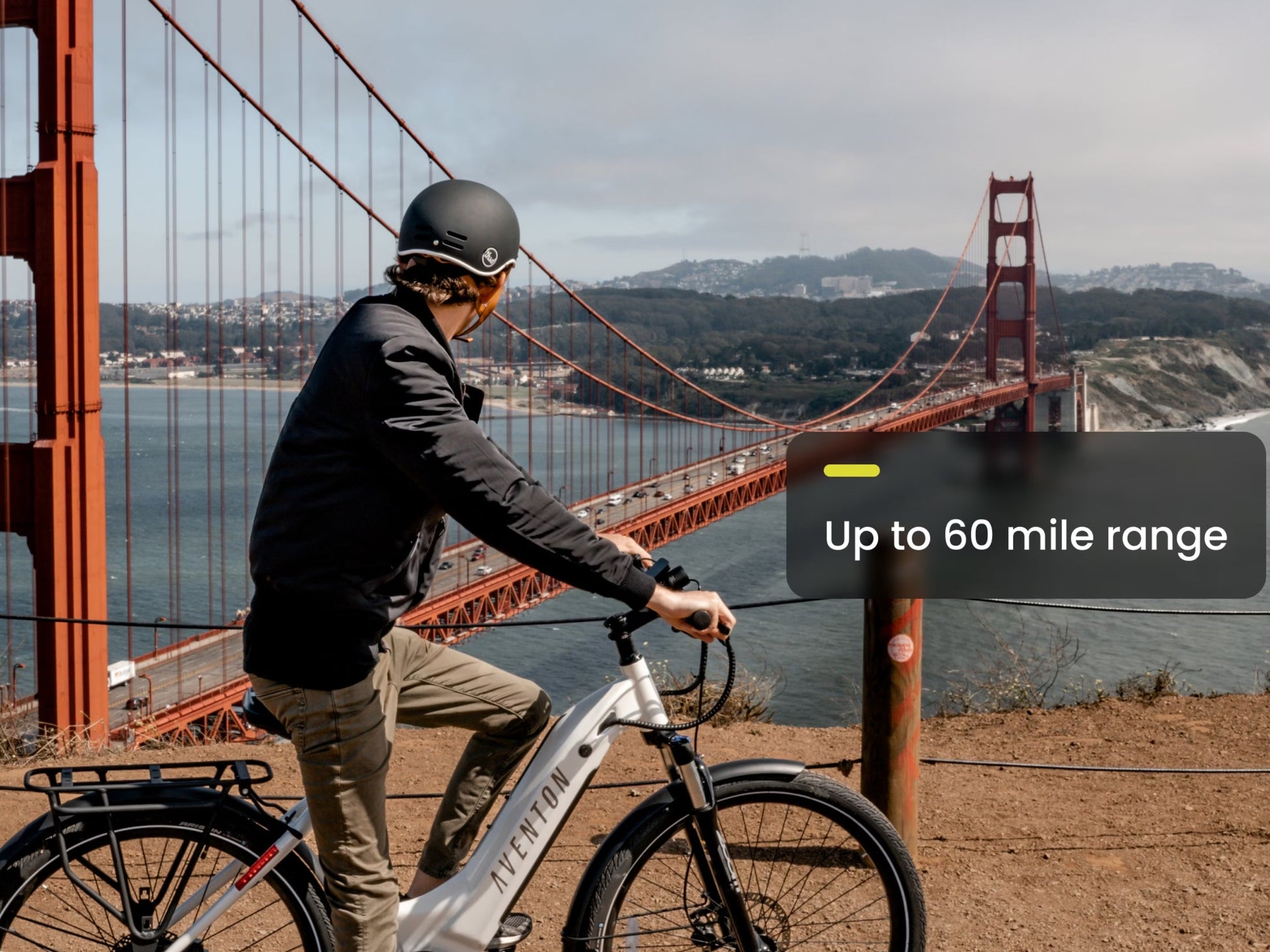 Aventon Level 2 Step_Through eBike Road / commuter Male rider overlooking a bridge. 60 mile range