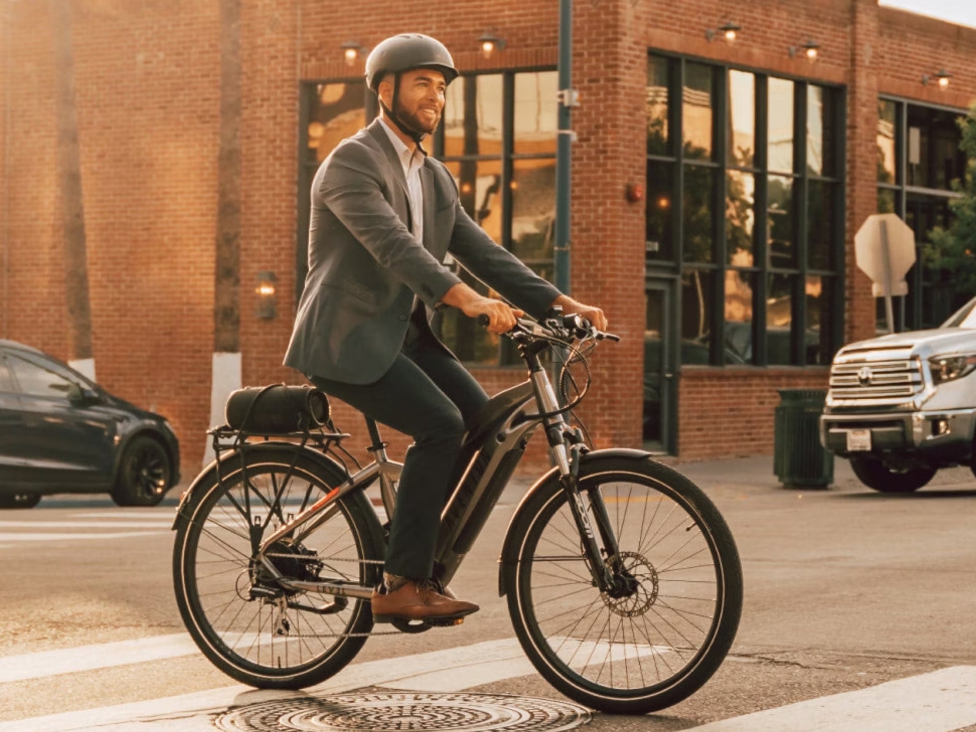 Aventon Level 2 eBike Road / commuter Male rider on street with brick building background
