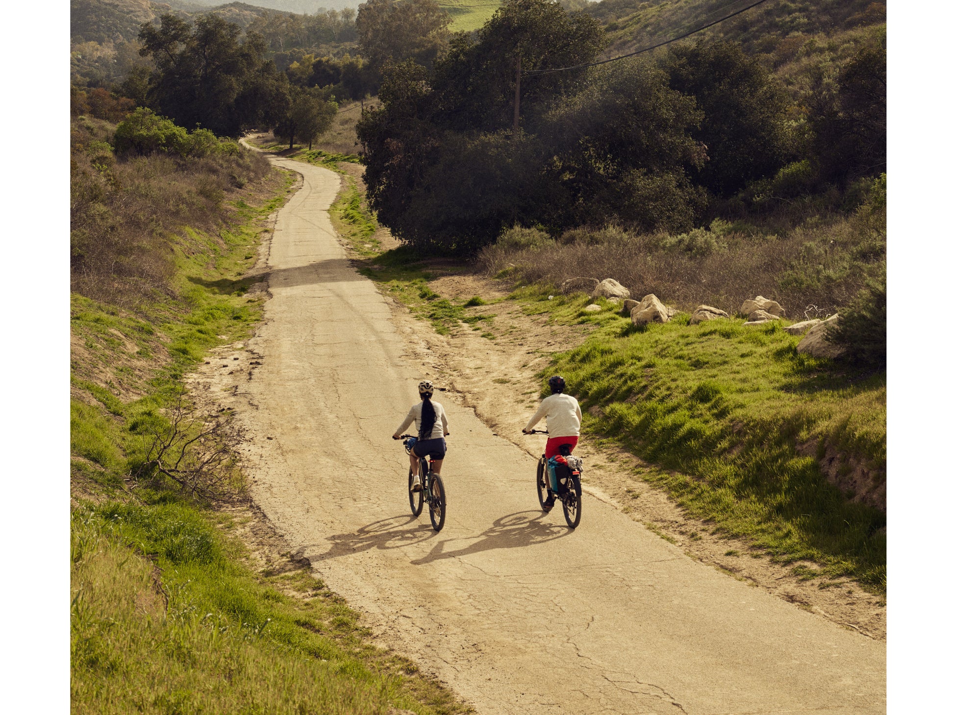 Cannondale Adventure Neo Allroad Electric bike. Road / commuter Two riders on hard packed dirt path