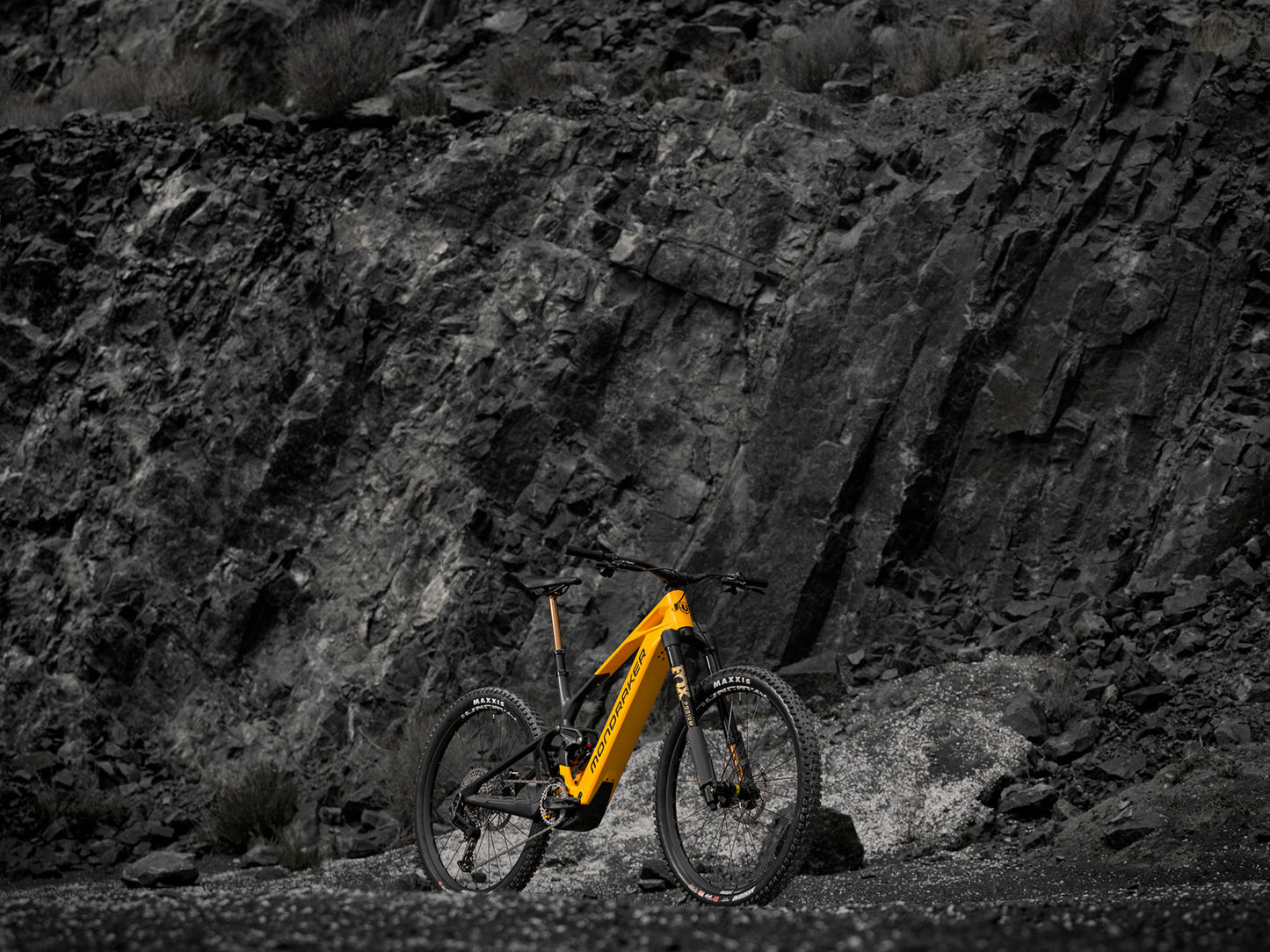 Mondraker Crafty Carbon RR S Full Suspension eMTB Enduro Dense yellow Forward facing view in a rocky desert setting