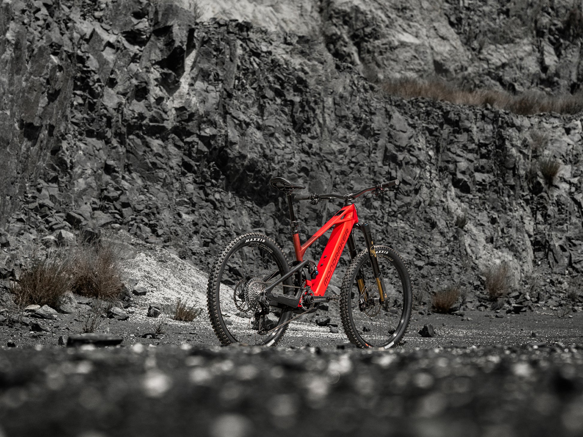 Mondraker Crafty Carbon XR Full Suspension Enduro eMTB Flame red Rear facing view in a Rocky desert setting
