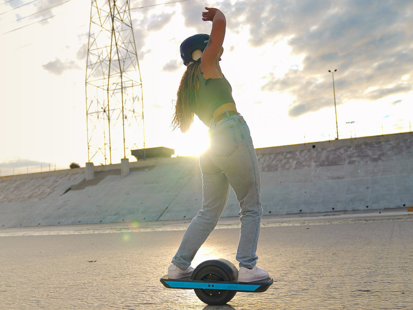 OneWheel Pint X Board Powder blue. Woman riding in dry river bed