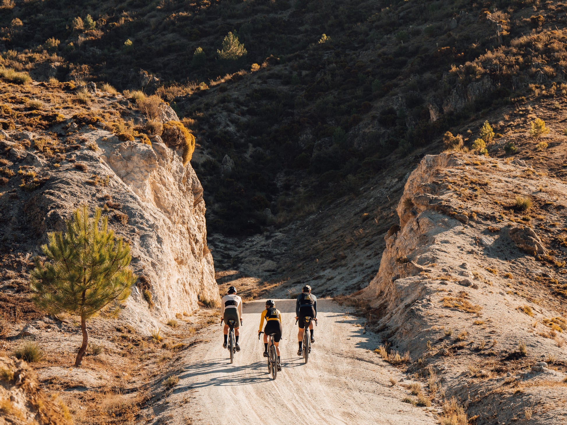 Orbea Denna Gravel Road / commuter Lifestyle Three riders on dirt trail in mountainside