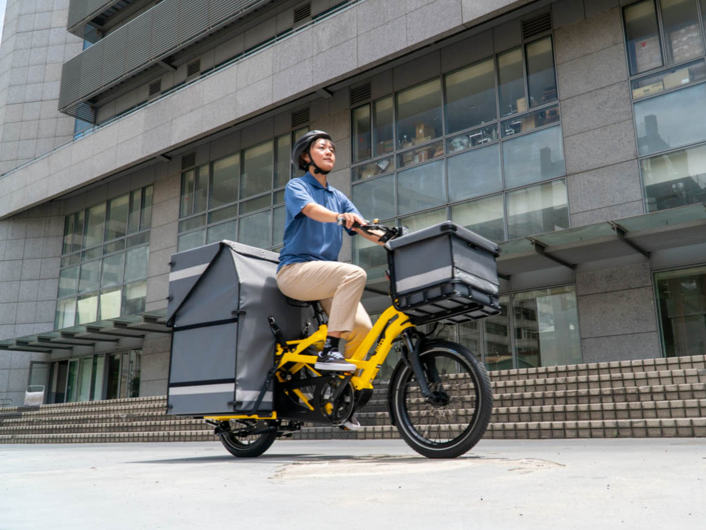Tern GSD S10 electric cargo bike School bus yellow. Lifestyle, rider with cargo on city streets