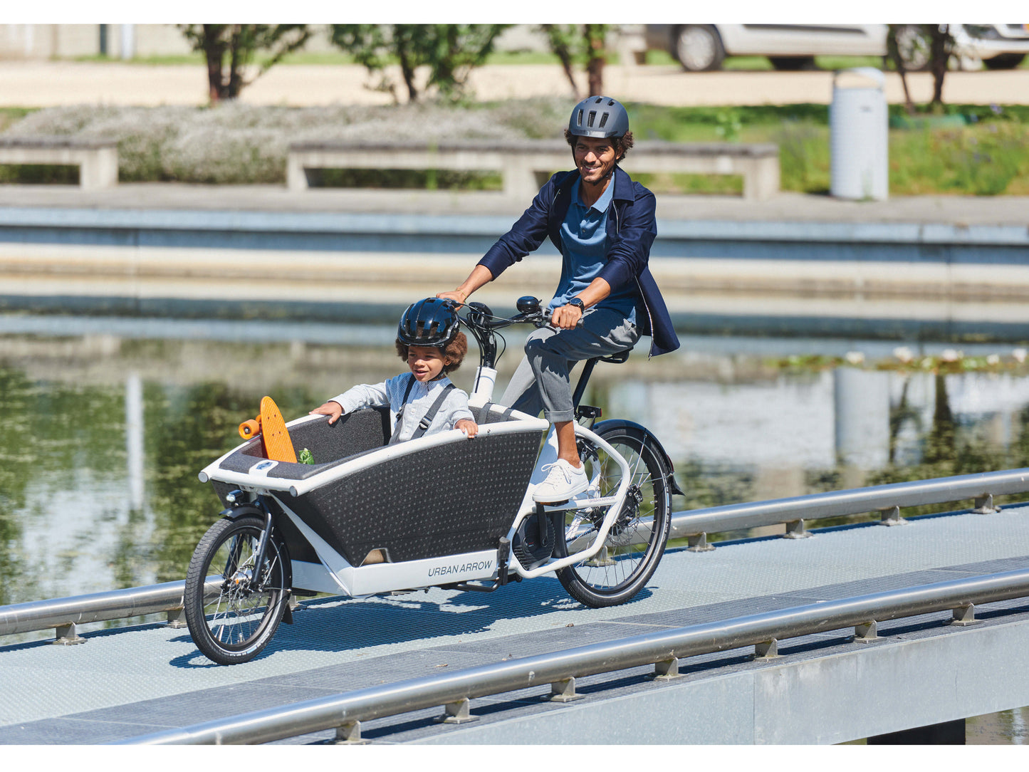 Urban Arrow Family Cargo electric bike man riding city path with child in front
