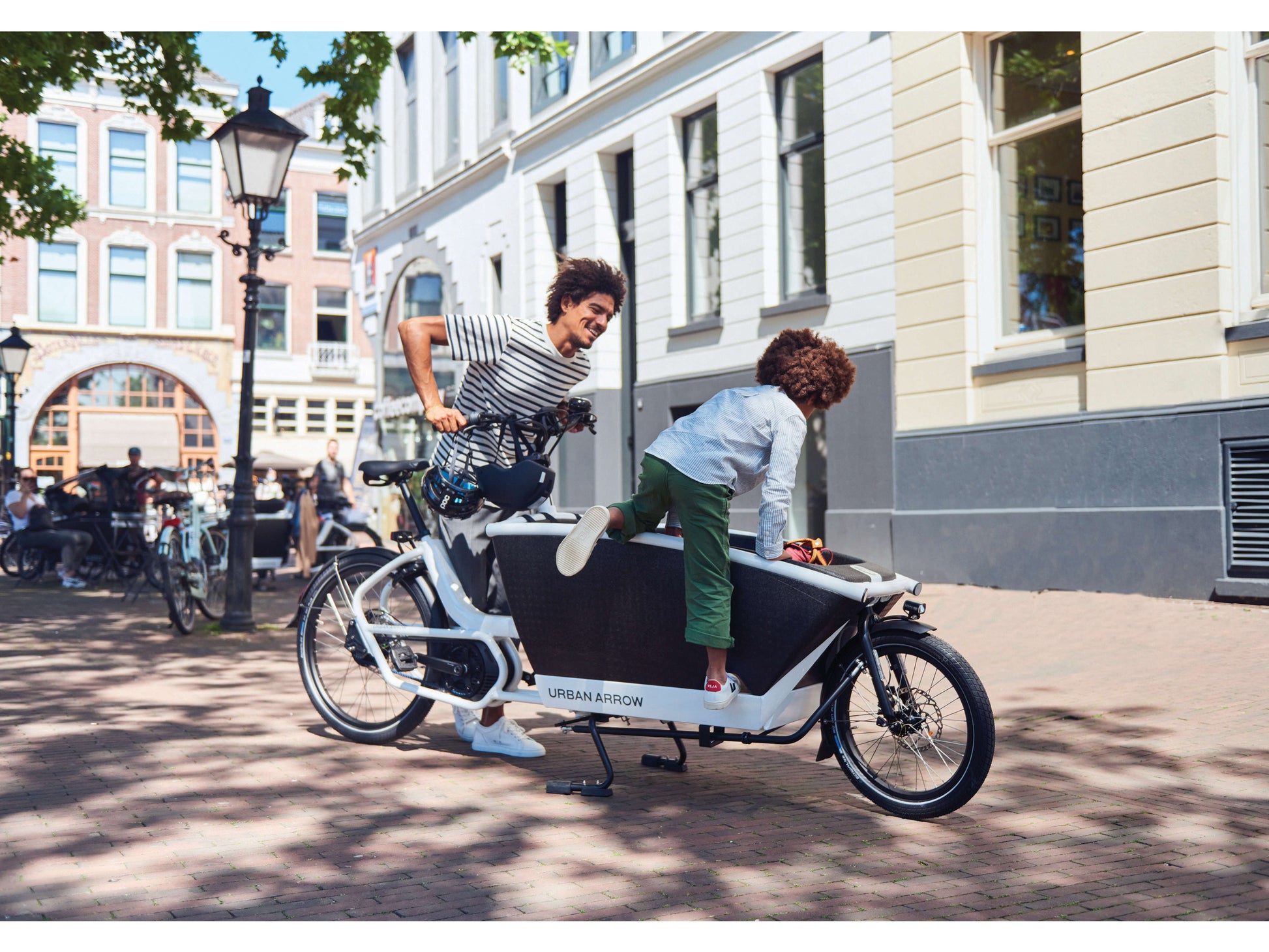Urban Arrow Family Cargo electric bike man with child climbing in front