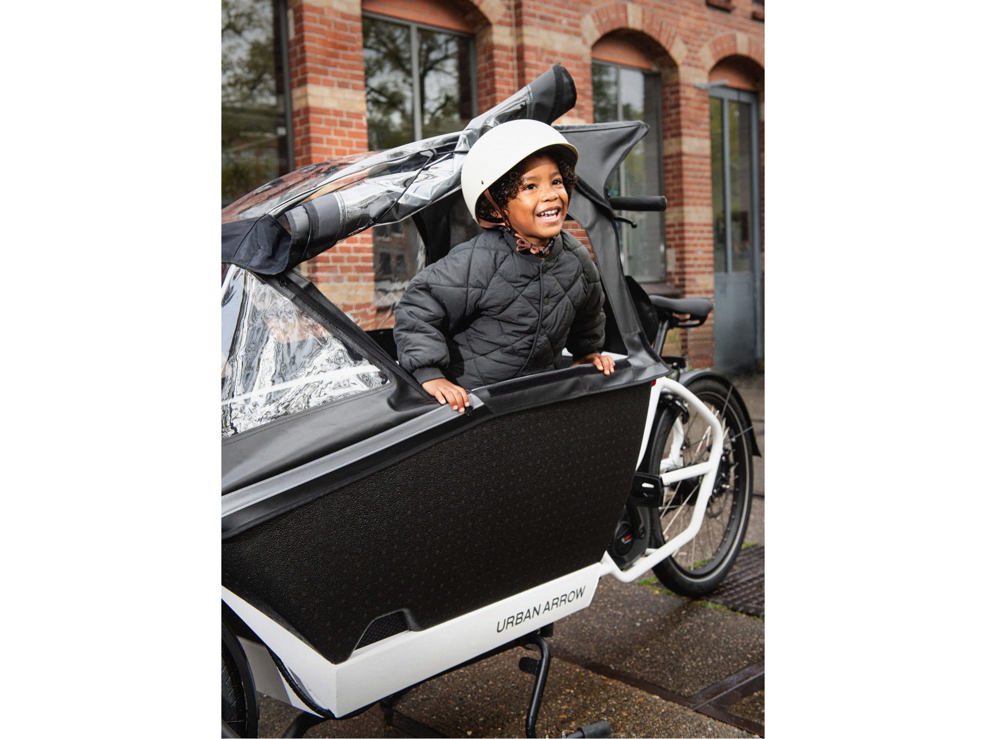 Urban Arrow Family Rain Cover Plus Child Shown going for a ride