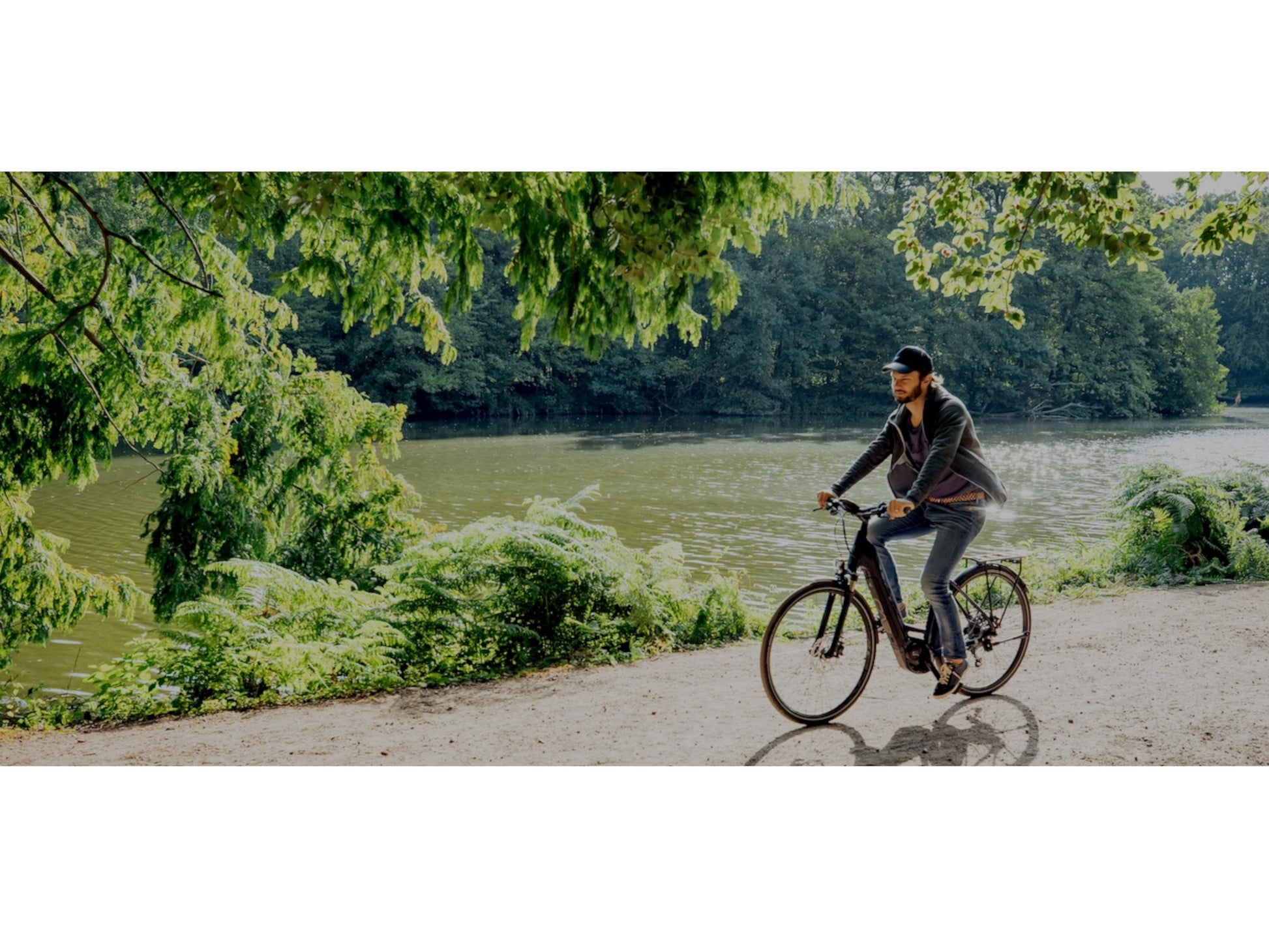 Bulls Sentinel 3 eMTB hardtail bike man riding bike path with lake in background