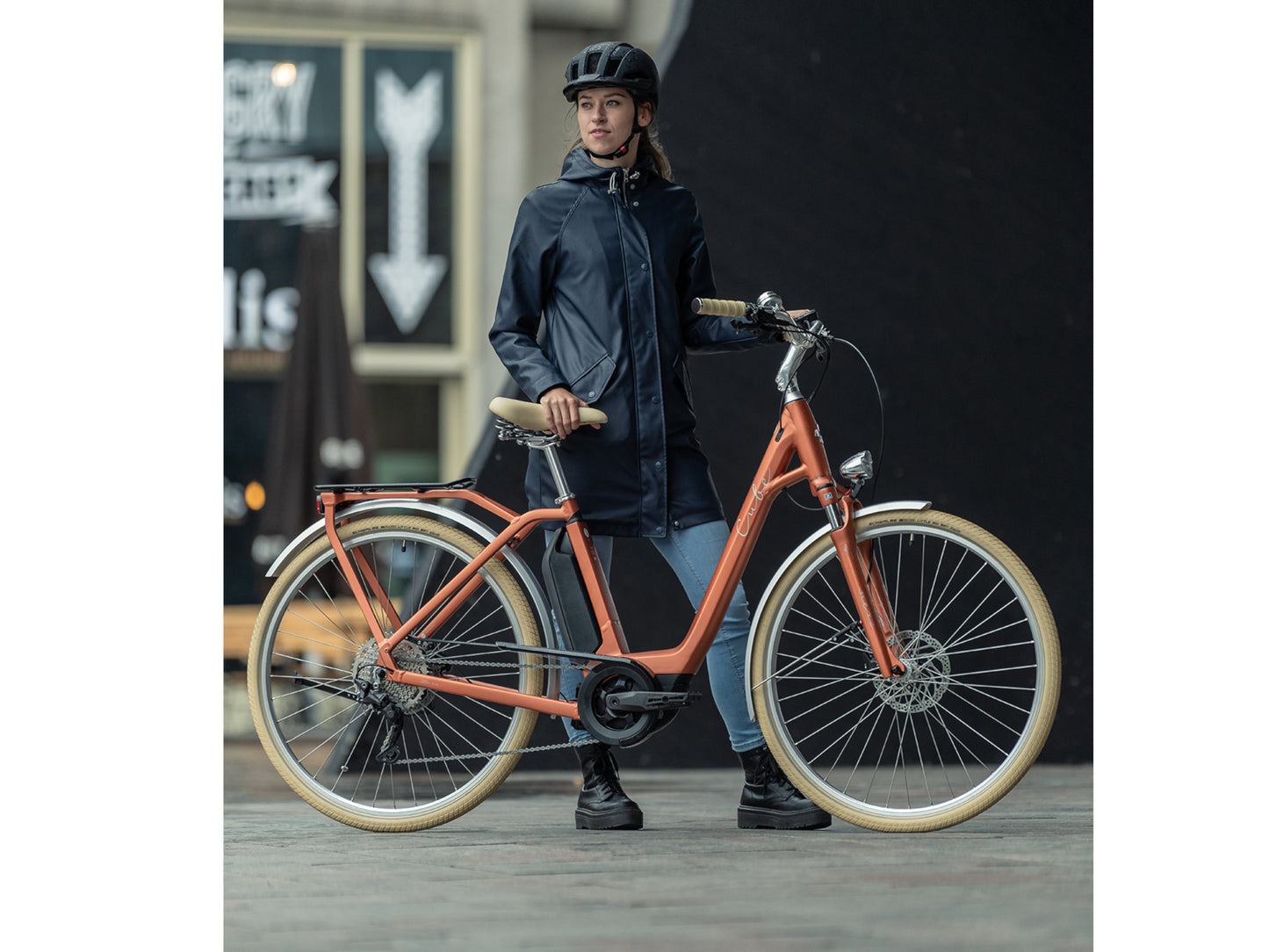 Cube Ella Ride Hybrid 500 eMTB hardtail woman standing with bike in city