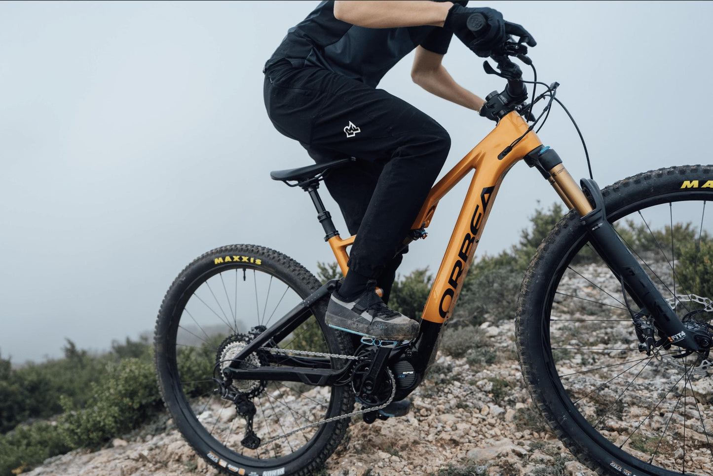 Orbea Rise Hydro H30 electric mountain bike in orange and black action shot close up on Fly Rides