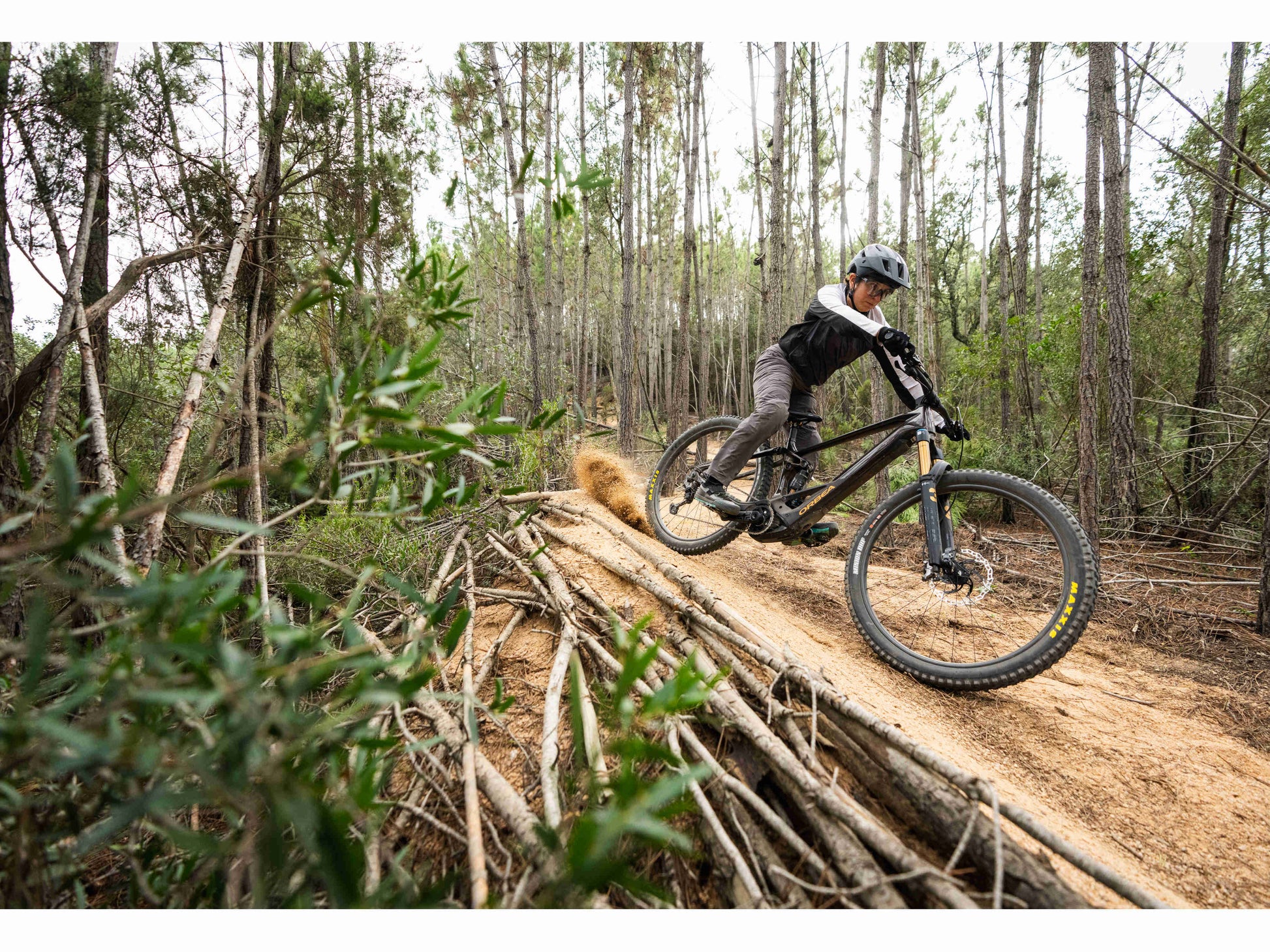 Orbea Wild  M-LTD eMTB full suspension man racing down forest single track