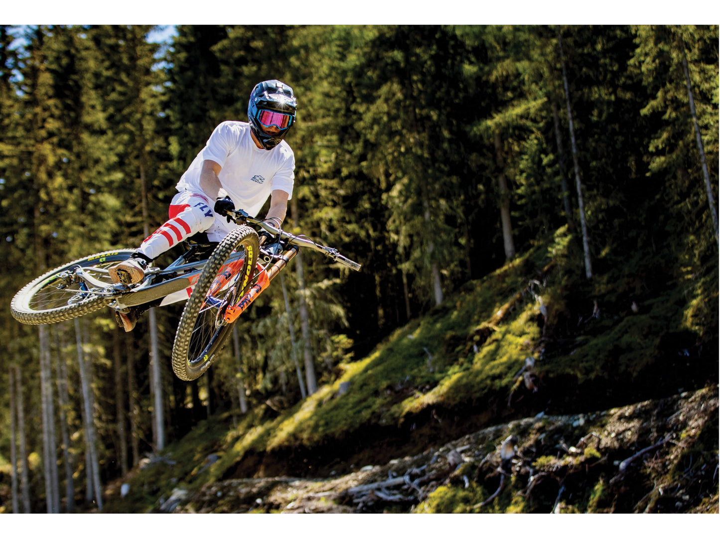 Pivot Shuttle SL Team XTR eMTB full suspension downhill Rider catching air forest trail