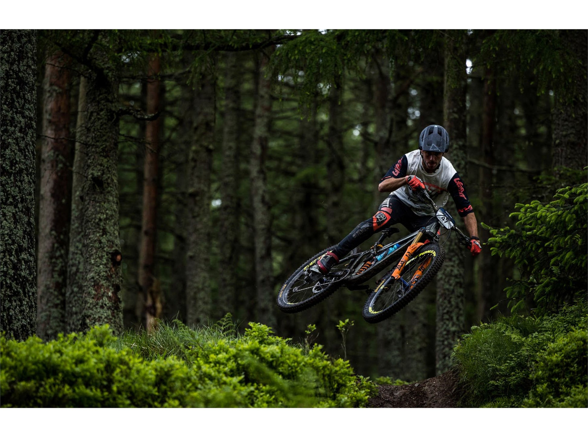 Pivot Shuttle SL Team XTR eMTB full suspension man riding downhill single track forest trail