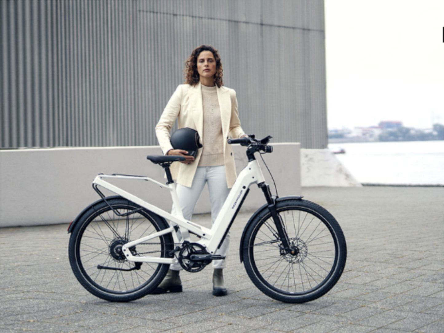 Riese and Muller Homage GT Vario ebike pearl white lady standing with bike