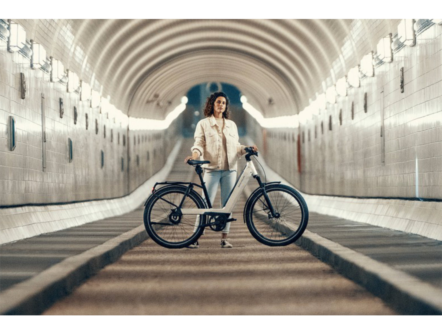 Riese and Muller Nevo GT Vario emtb hardtail woman in city tunnel bike path