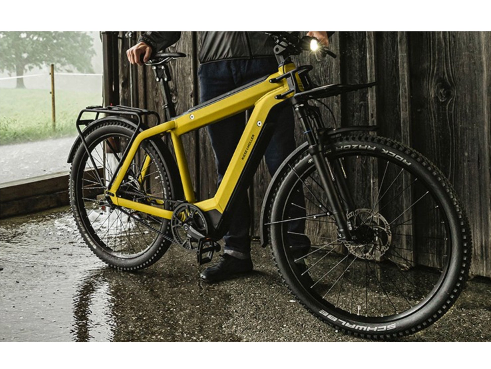 Riese and Muller Supercharger GT Rohloff HS emtb hardtail man standing under shelter rain storm
